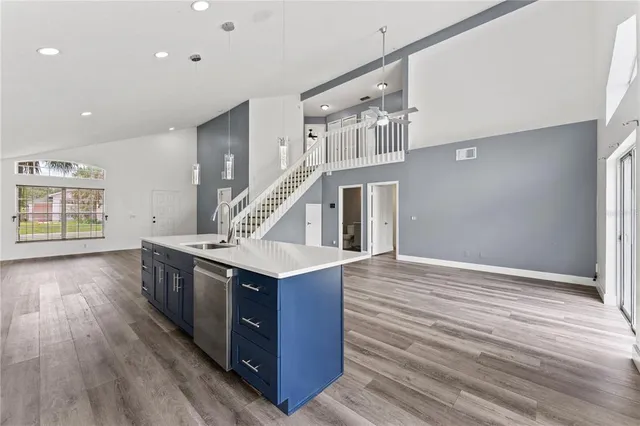 a kitchen with stainless steel appliances granite countertop a stove and a wooden floors