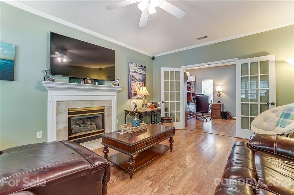 744 West Cheval Drive Fort Mill, SC 29708 - Photo 13 of 47 a living room with furniture a flat screen tv and a fireplace