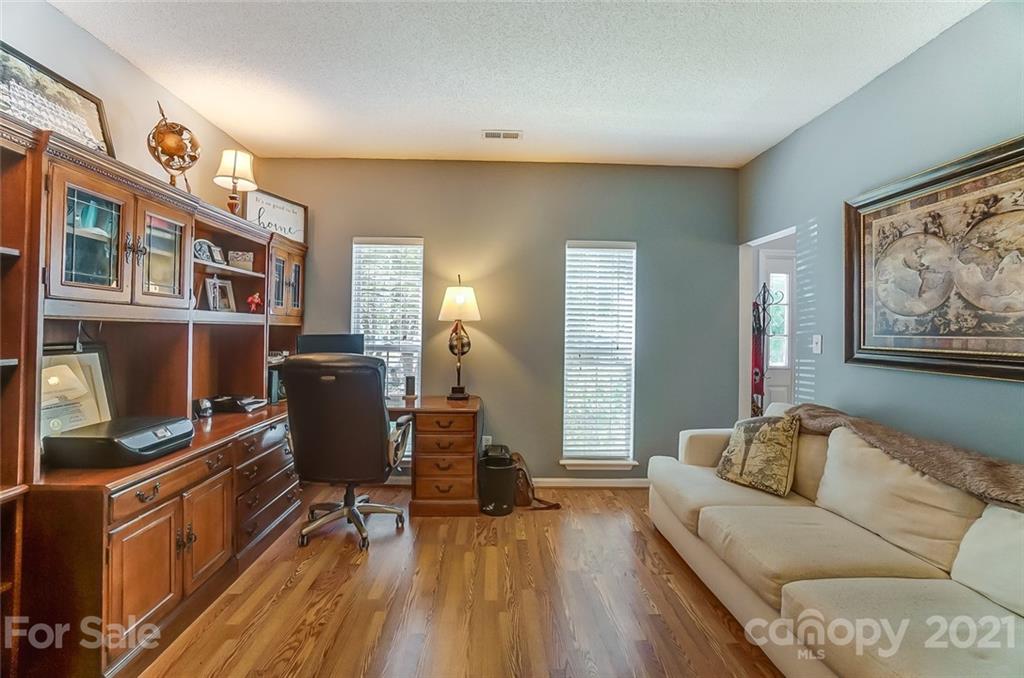 744 West Cheval Drive Fort Mill, SC 29708 - Photo 14 of 47 a living room with furniture and a flat screen tv with wooden floor