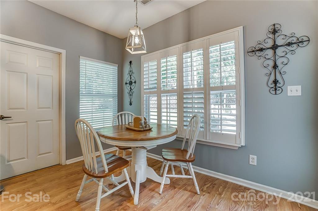 744 West Cheval Drive Fort Mill, SC 29708 - Photo 20 of 47 a dining room with chandelier and wooden floor