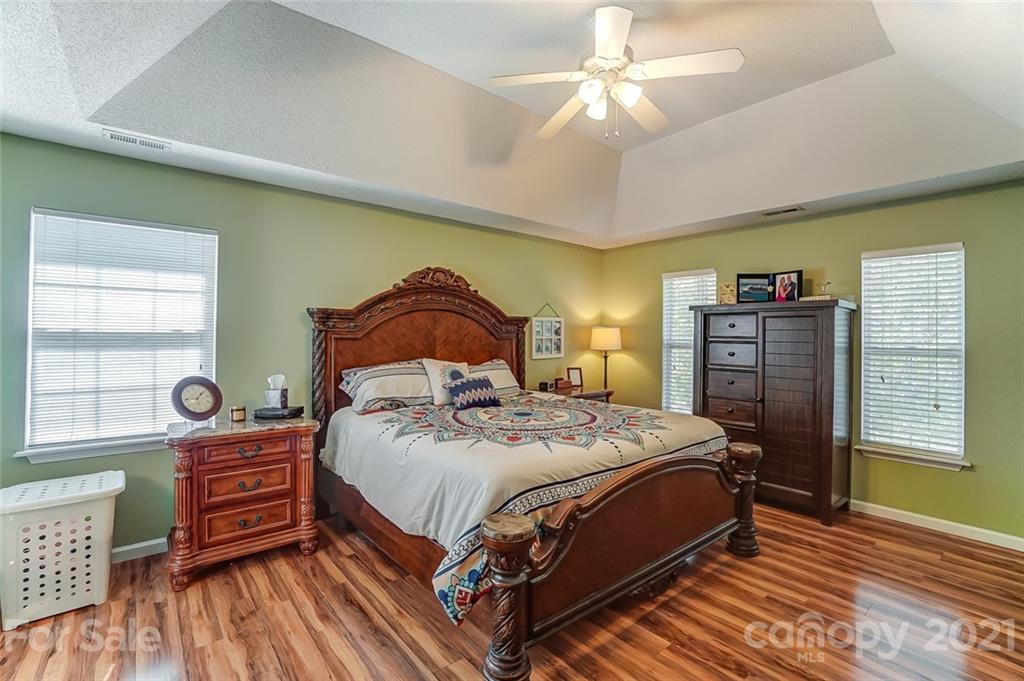 744 West Cheval Drive Fort Mill, SC 29708 - Photo 23 of 47 a bedroom with a bed and wooden floor