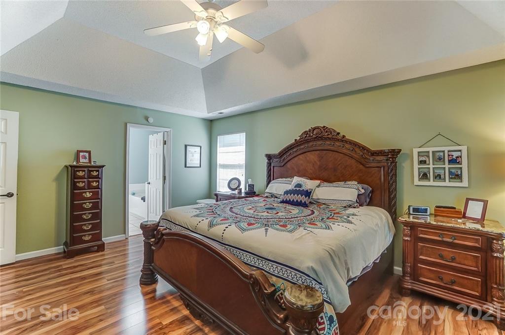 744 West Cheval Drive Fort Mill, SC 29708 - Photo 24 of 47 a bedroom with a bed and wooden floor