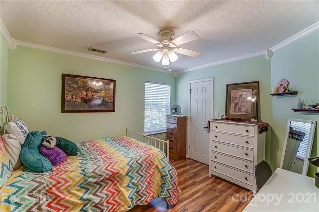 744 West Cheval Drive Fort Mill, SC 29708 - Photo 27 of 47 a bedroom with a bed and a dresser in it