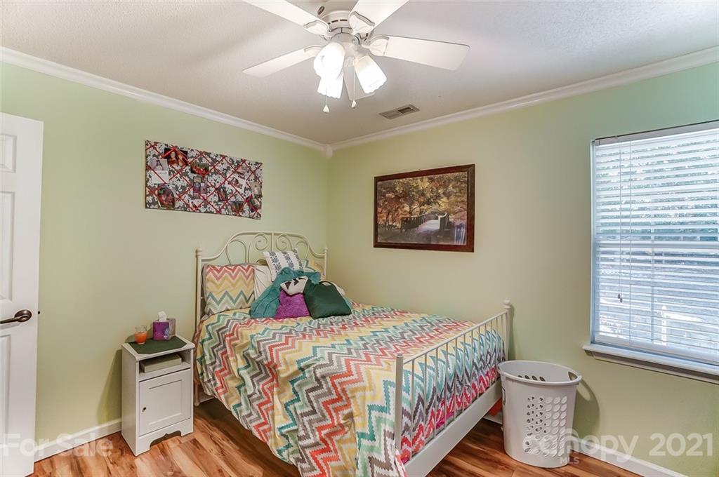 744 West Cheval Drive Fort Mill, SC 29708 - Photo 28 of 47 a bedroom with a bed and a chandelier
