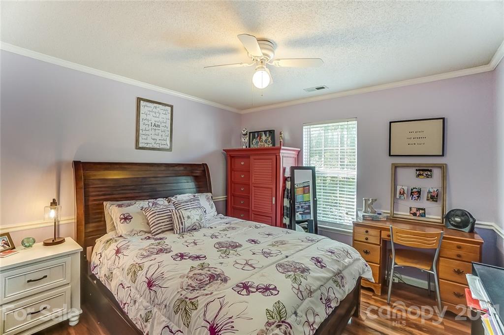 744 West Cheval Drive Fort Mill, SC 29708 - Photo 29 of 47 a bedroom with a bed and a table in it