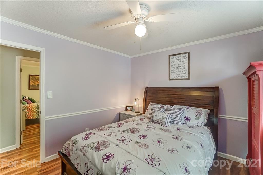 744 West Cheval Drive Fort Mill, SC 29708 - Photo 30 of 47 a bedroom with a bed and a chandelier