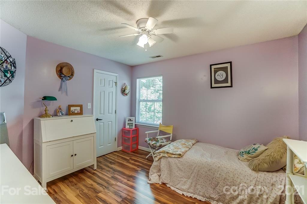 744 West Cheval Drive Fort Mill, SC 29708 - Photo 32 of 47 a bedroom with a bed and a chandelier