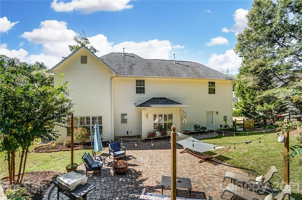 744 West Cheval Drive Fort Mill, SC 29708 - Photo 39 of 47 a patio with table and chairs under an umbrella