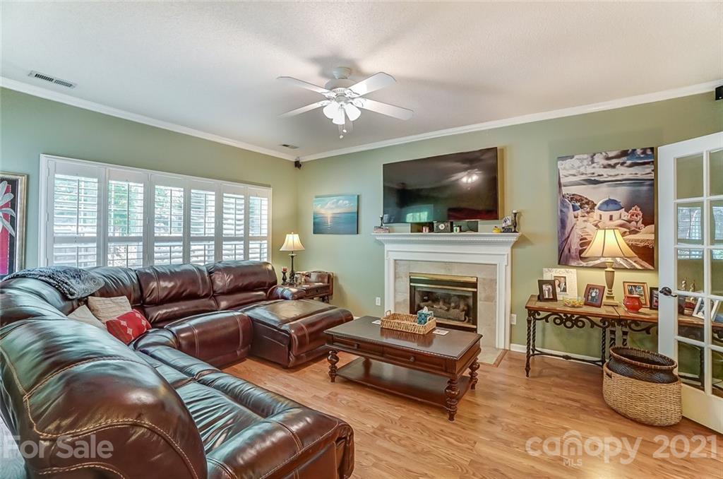 744 West Cheval Drive Fort Mill, SC 29708 - Photo 10 of 47 a living room with furniture a flat screen tv and a fireplace