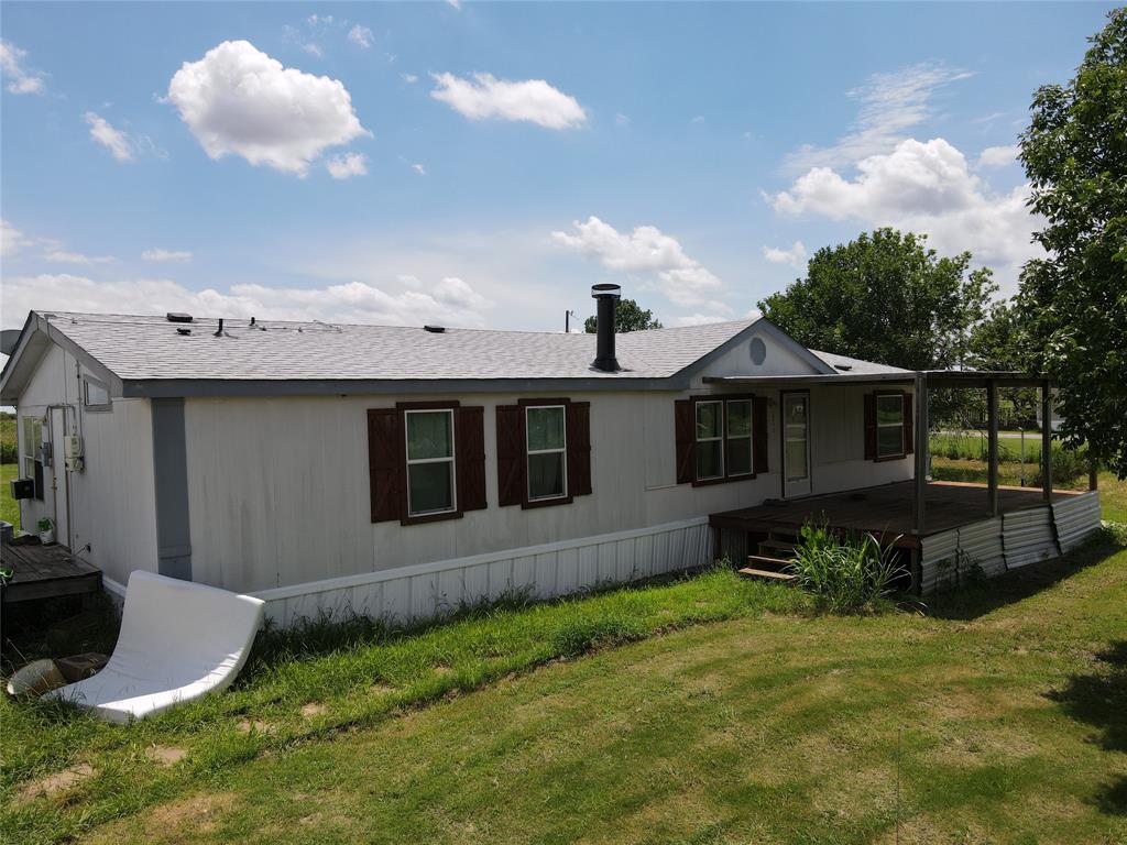 15962 Fritcher Road Pilot Point, TX 76258 - Photo 14 of 24 a front view of a house with garden