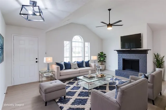a living room with furniture a chandelier and a flat screen tv