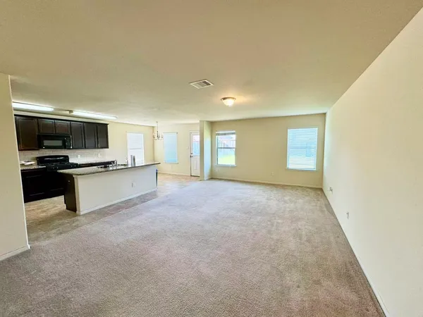 a view of a kitchen with microwave and cabinets