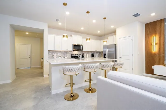 a bedroom with a bed and painting on the wall