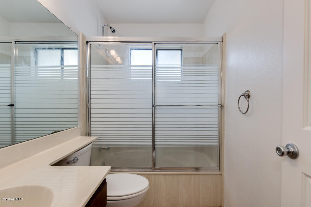 1222 West Baseline Road, Unit 112 Tempe, AZ 85283 - Photo 17 of 26 a bathroom with a toilet a sink and shower