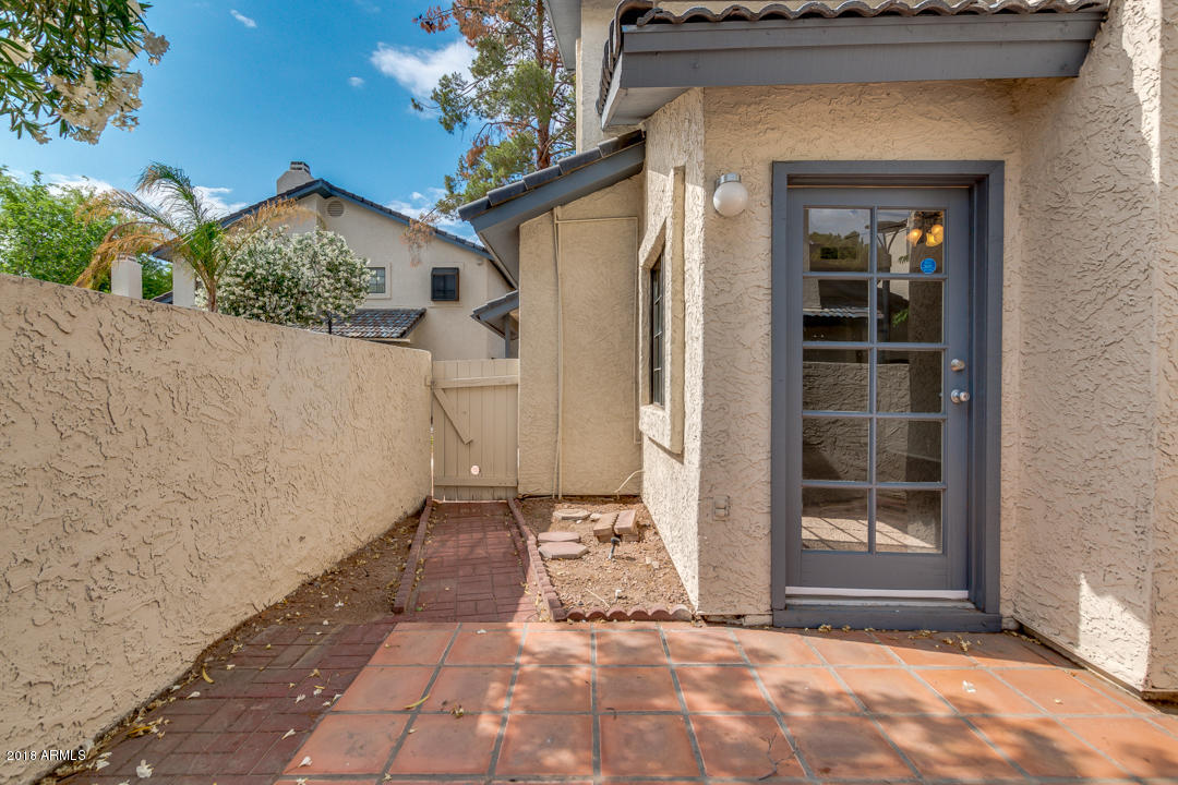1222 West Baseline Road, Unit 112 Tempe, AZ 85283 - Photo 23 of 26 a view of a front door and a yard
