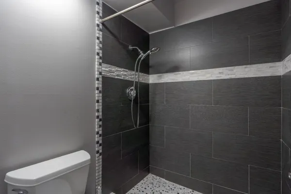 a bathroom with a toilet and a shower