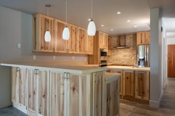 a kitchen with a white cabinets and window