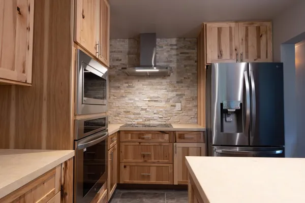 a kitchen with granite countertop a refrigerator and a stove