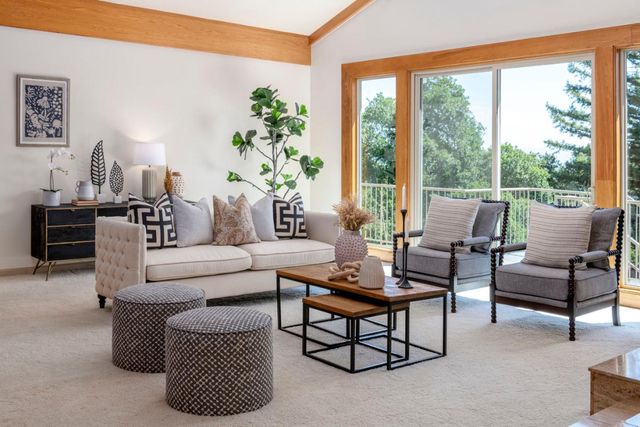 a dining room with wooden floor and a rug