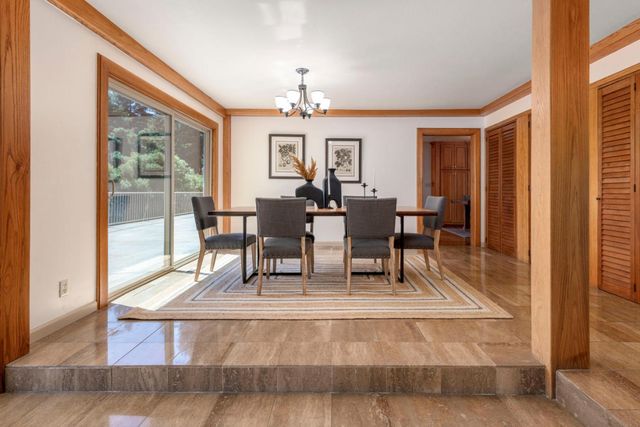 a kitchen with stainless steel appliances a white wooden cabinets a sink and a large window