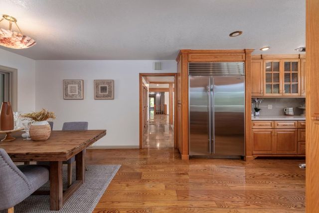 a living room with furniture a fireplace and a ceiling fan