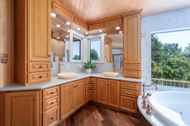 a bathroom with a granite countertop sink toilet mirror and shower