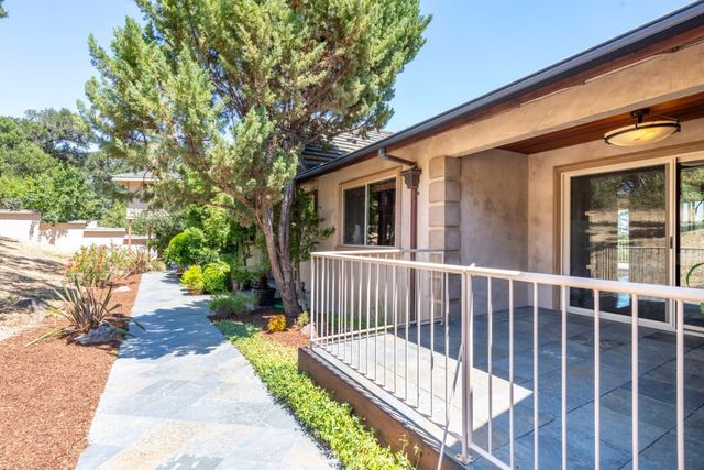 a view of a house with backyard and sitting area