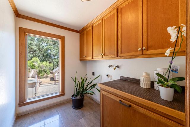 a large kitchen with wooden floor and stainless steel appliances