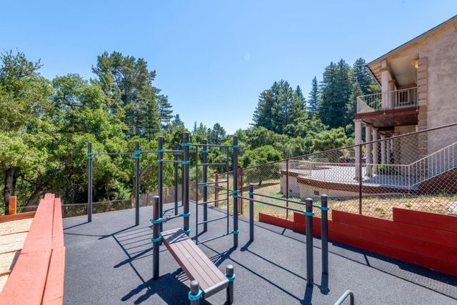 a view of a street with a large trees