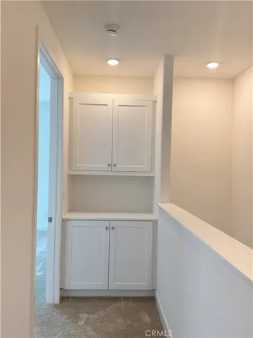 a view of an empty room and a window