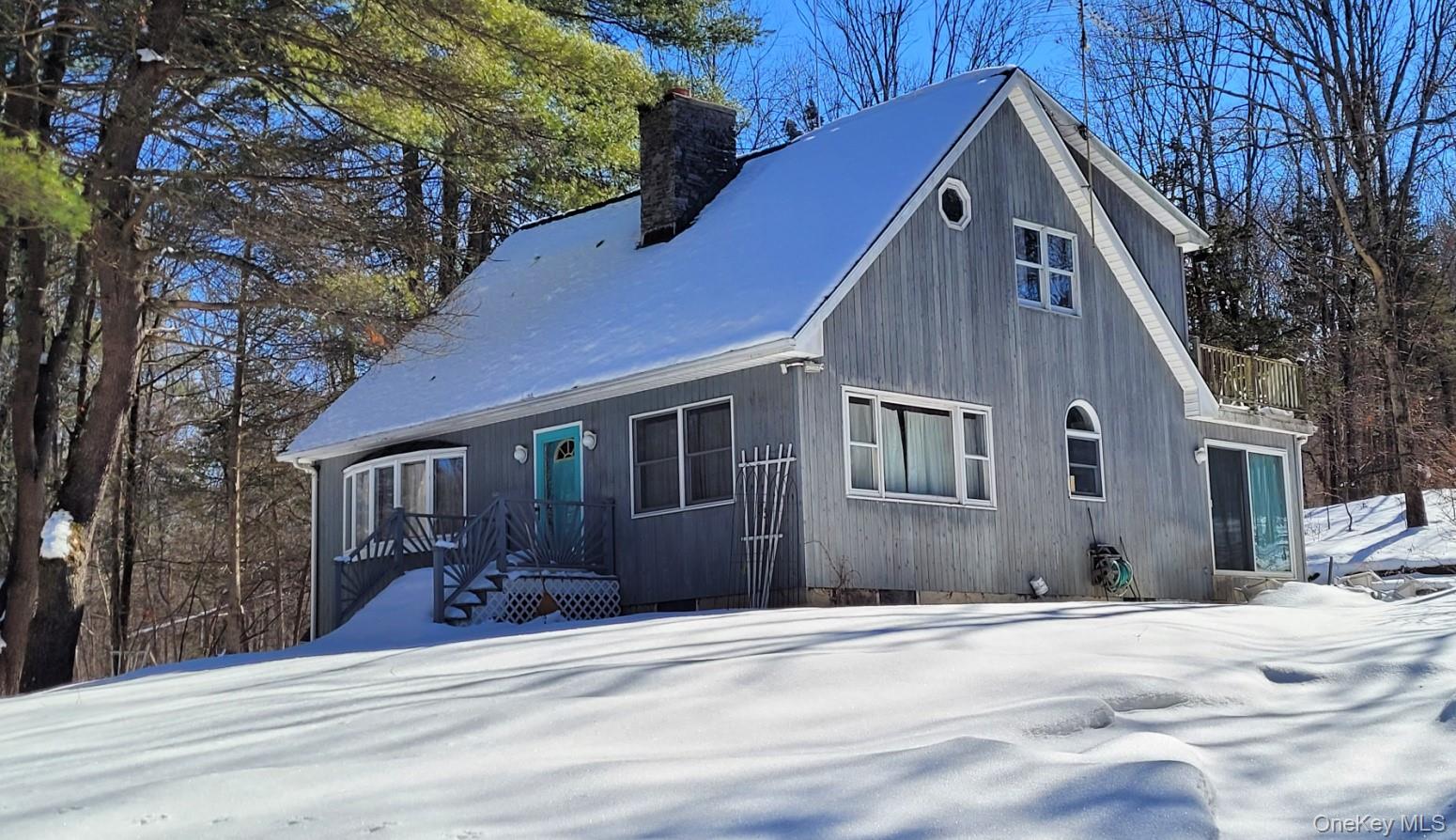 94 Hilltop Road Rhinebeck, NY 12572 - Photo 2 of 28 a front view of a house with a yard and garage