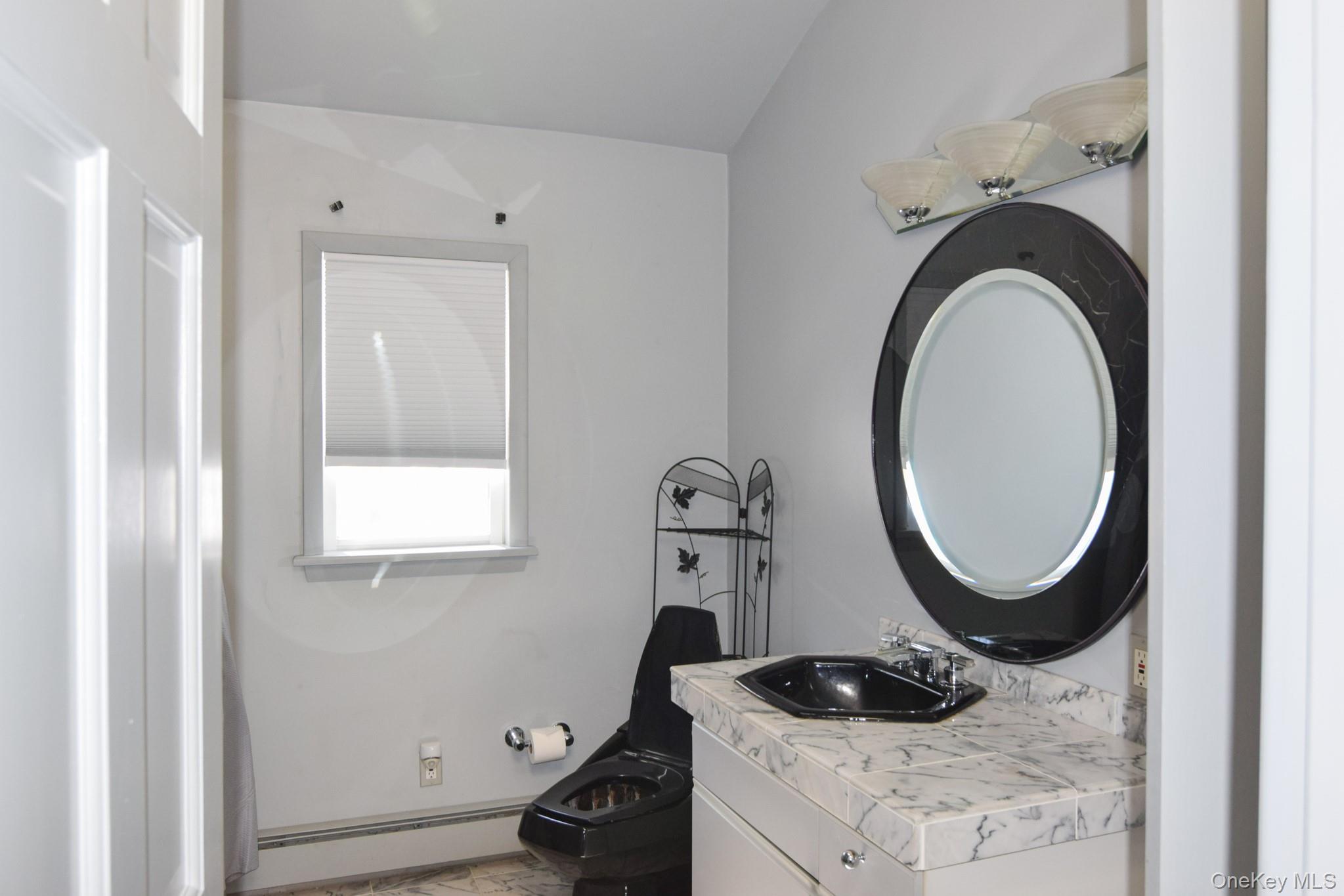 94 Hilltop Road Rhinebeck, NY 12572 - Photo 21 of 28 a close view of a sink and a mirror