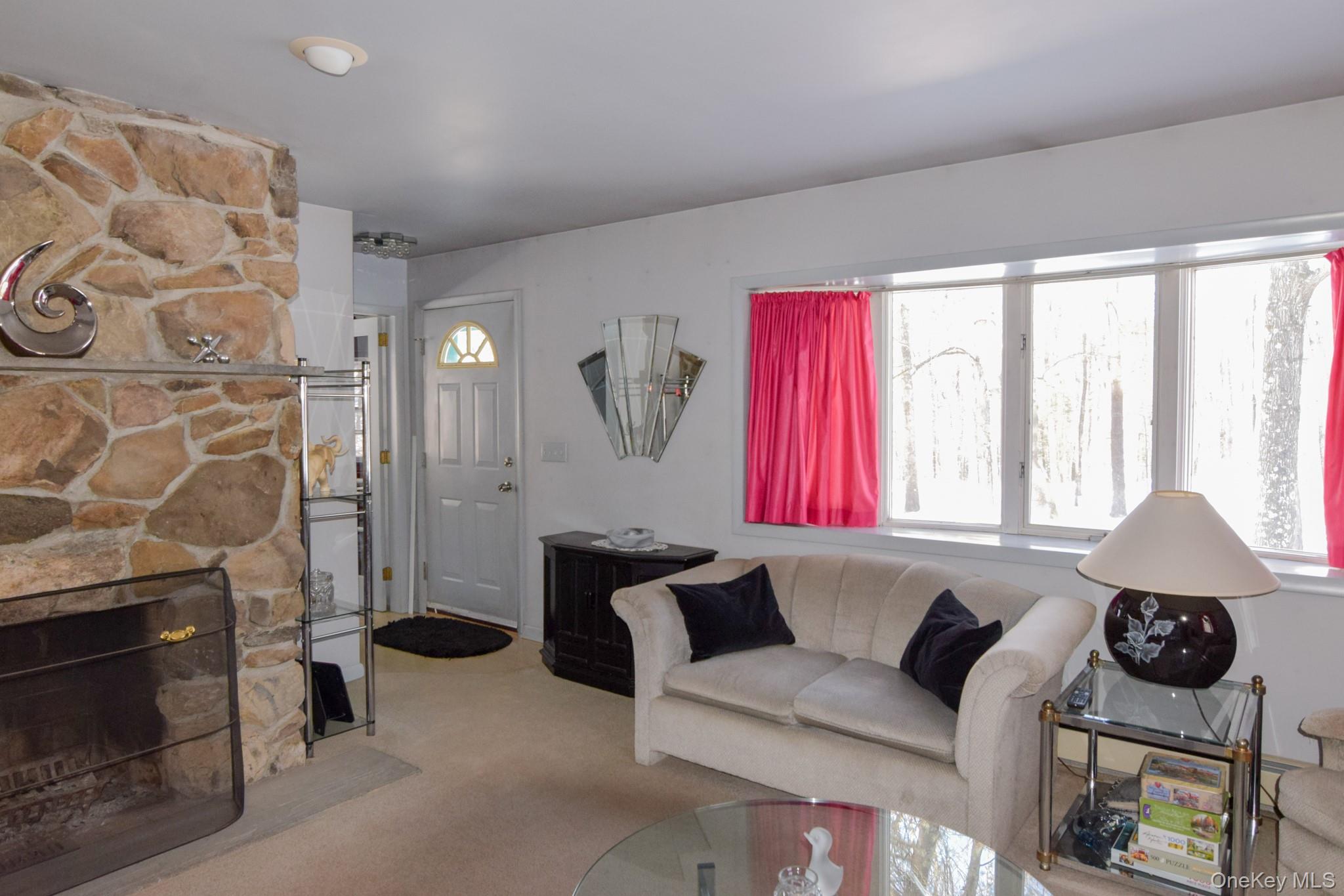94 Hilltop Road Rhinebeck, NY 12572 - Photo 3 of 28 a living room with furniture and a fireplace