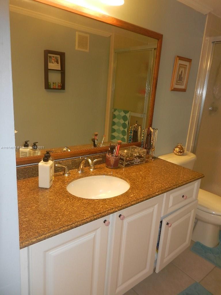 721 North Pine Island Road, Unit 112 Plantation, FL 33324 - Photo 17 of 27 a bathroom with a granite countertop sink and a mirror
