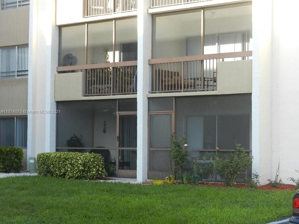 721 North Pine Island Road, Unit 112 Plantation, FL 33324 - Photo 2 of 27 a front view of a house with a yard