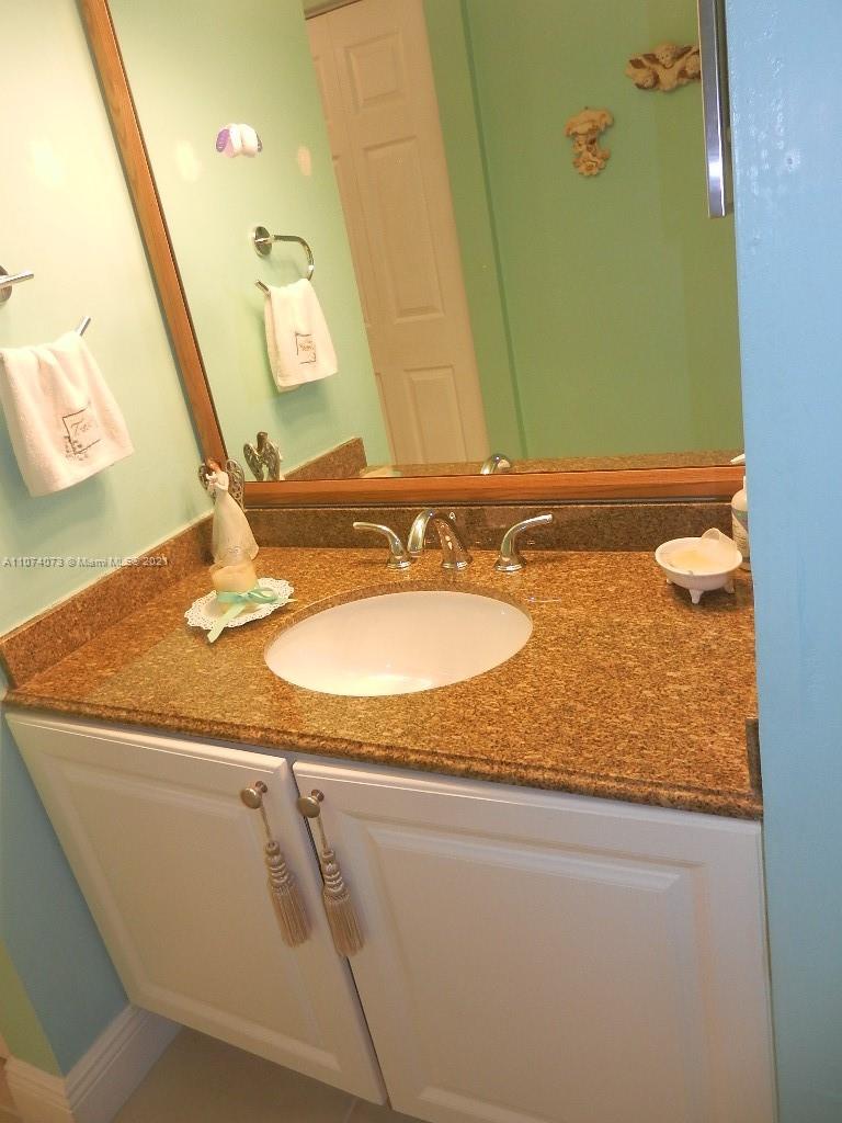 721 North Pine Island Road, Unit 112 Plantation, FL 33324 - Photo 24 of 27 a bathroom with a granite countertop sink and a mirror