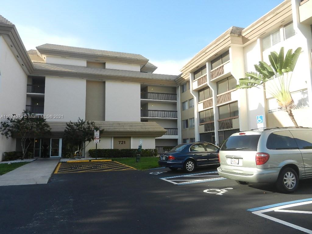 721 North Pine Island Road, Unit 112 Plantation, FL 33324 - Photo 26 of 27 a view of a car parked in front of a house