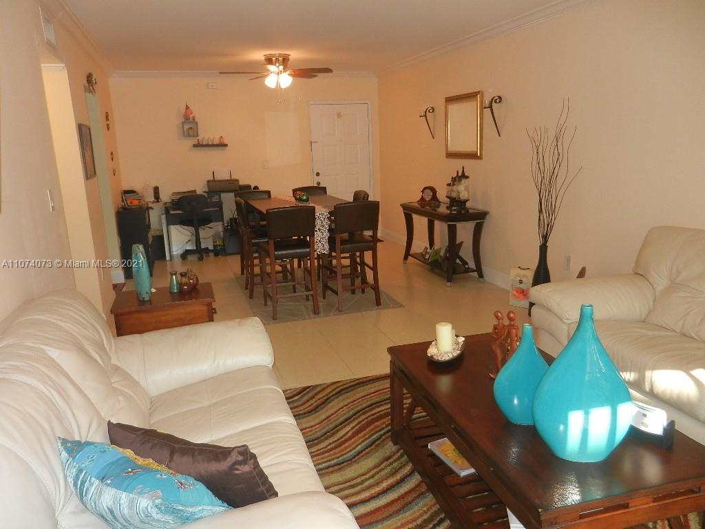 721 North Pine Island Road, Unit 112 Plantation, FL 33324 - Photo 3 of 27 a living room with furniture and wooden floor