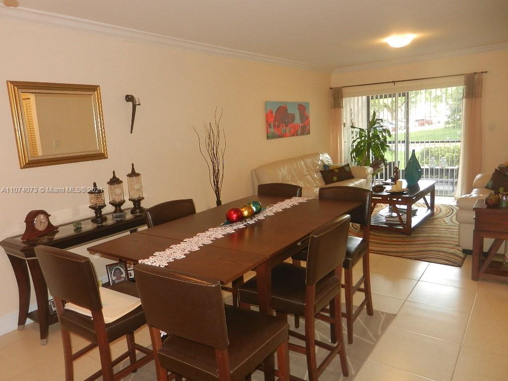 721 North Pine Island Road, Unit 112 Plantation, FL 33324 - Photo 6 of 27 a view of a dining room with furniture window and outside view