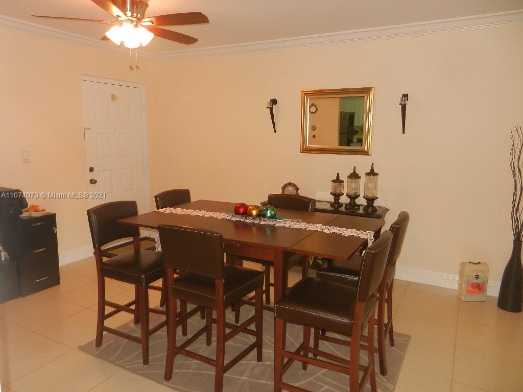 721 North Pine Island Road, Unit 112 Plantation, FL 33324 - Photo 8 of 27 a view of a dining room with furniture and a chandelier fan