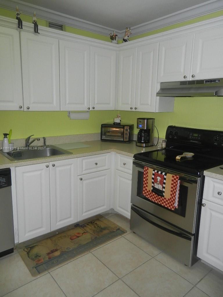 721 North Pine Island Road, Unit 112 Plantation, FL 33324 - Photo 10 of 27 a kitchen with stainless steel appliances granite countertop a stove a sink and a microwave