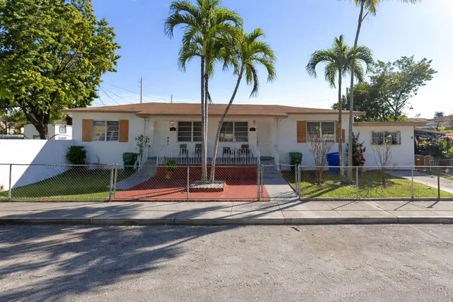 a view of palm trees in front of a house