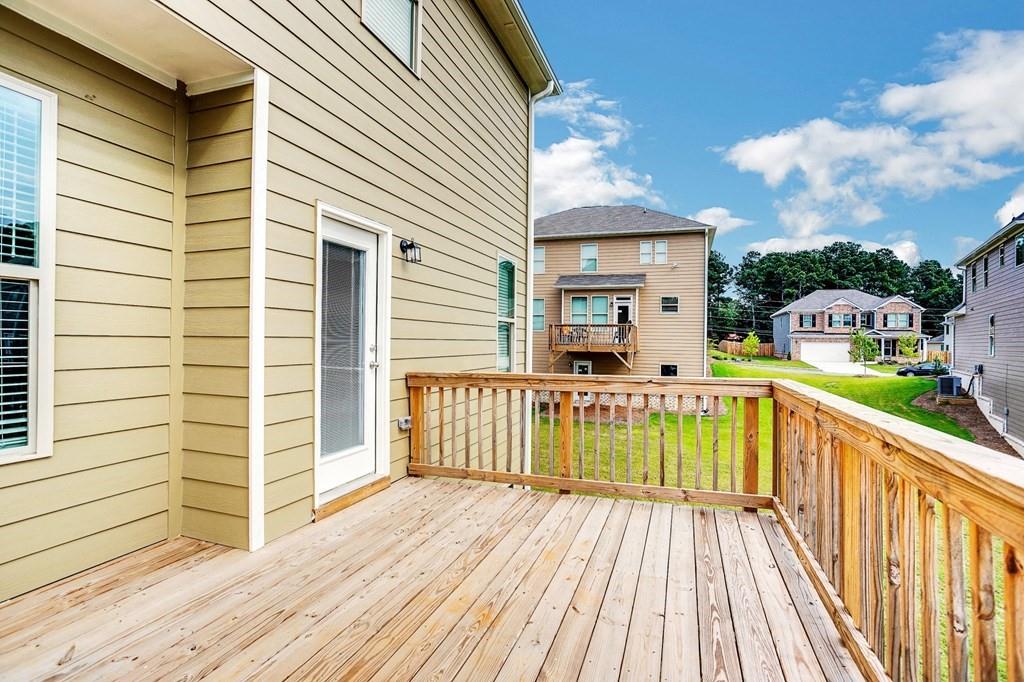 1852 Auburn Road, Unit RIVERBROOK Dacula, GA 30019 - Photo 20 of 31 a view of a house with a wooden deck