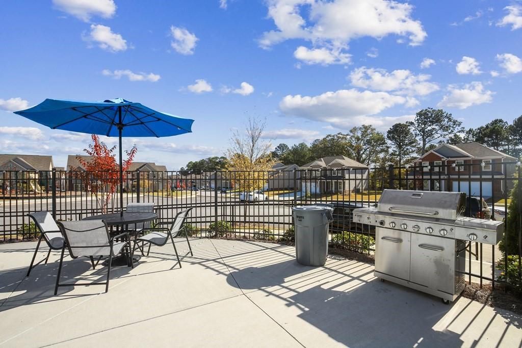 1852 Auburn Road, Unit RIVERBROOK Dacula, GA 30019 - Photo 26 of 31 a view of a terrace with furniture and stove