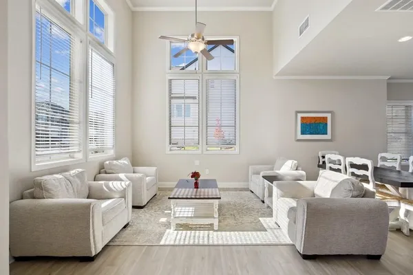 a living room with furniture a table and a large window