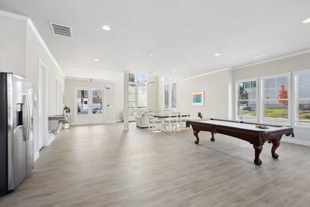 a living room with furniture pool table and a table
