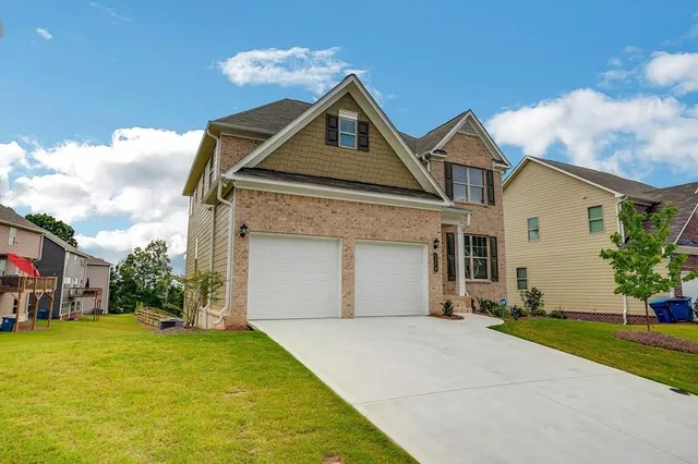a front view of a house with a yard and garage