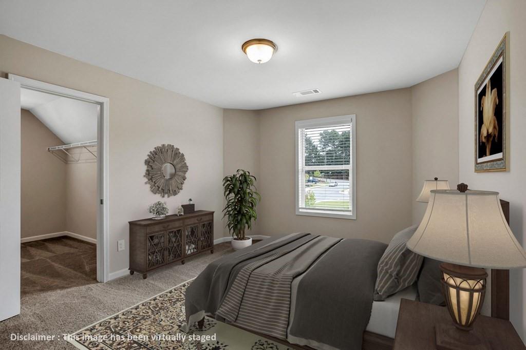 1852 Auburn Road, Unit RIVERBROOK Dacula, GA 30019 - Photo 10 of 31 a bedroom with a bed and a chandelier