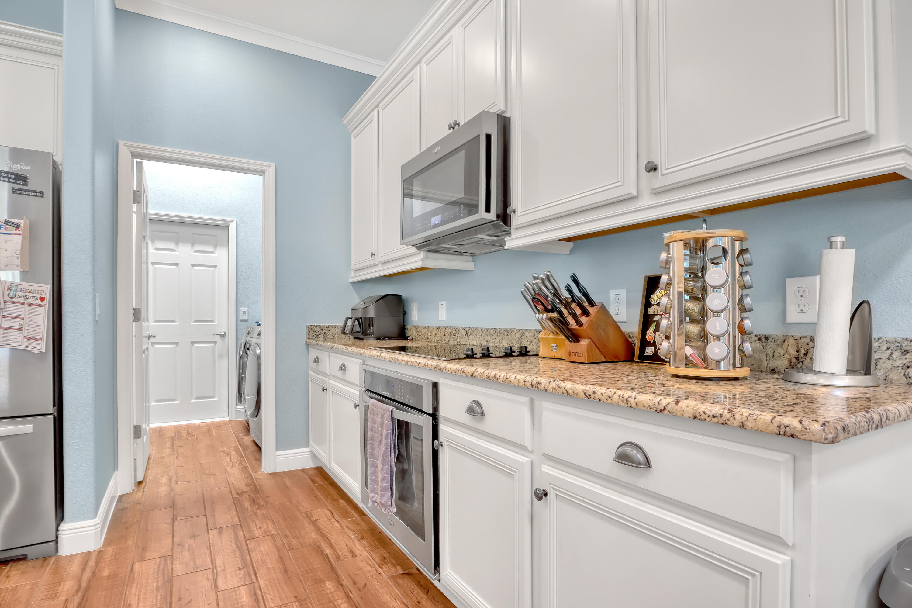 1358 Outrigger Circle Rockledge, FL 32955 - Photo 17 of 48 a kitchen with stainless steel appliances granite countertop a stove a sink and white cabinets
