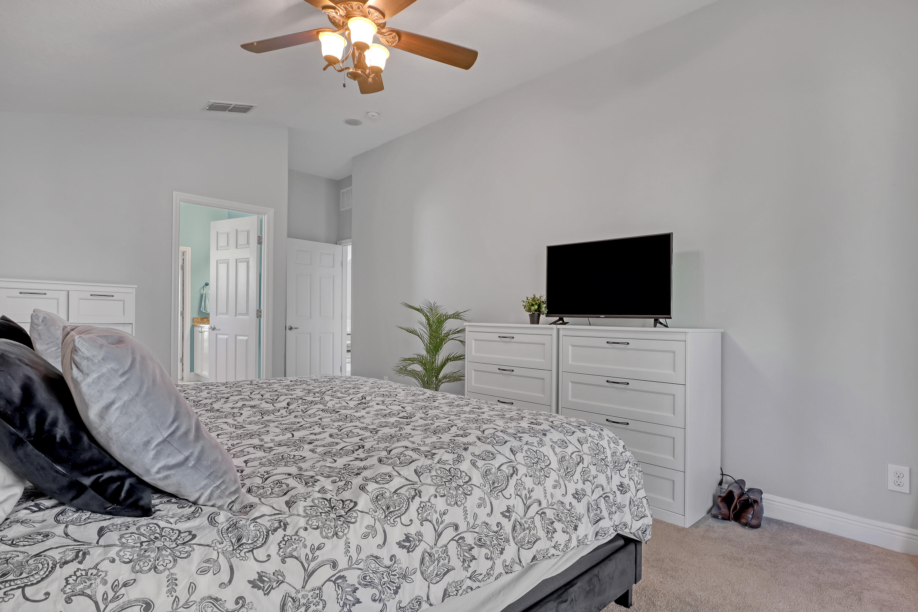 1358 Outrigger Circle Rockledge, FL 32955 - Photo 23 of 48 a bedroom with a bed and a flat screen tv